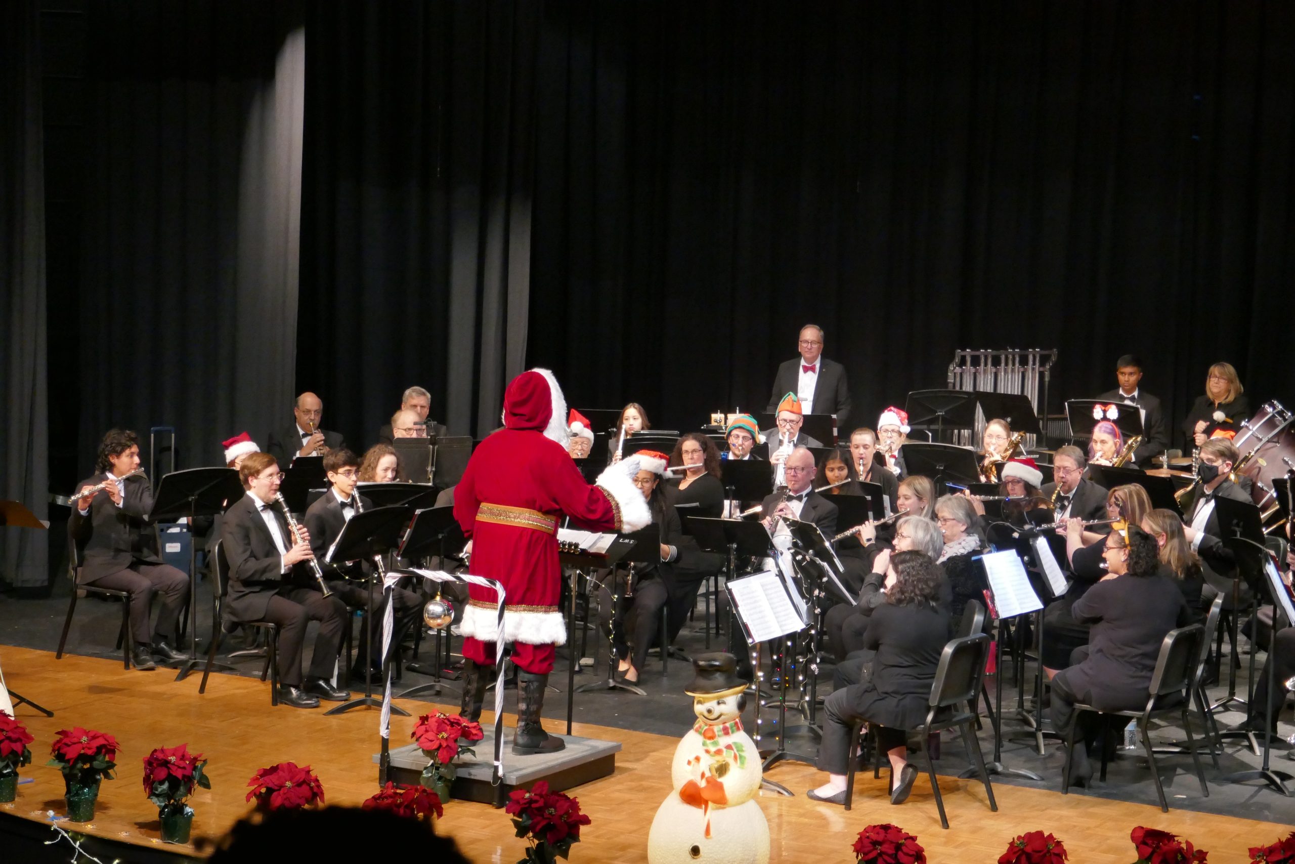 Santa conducting a concert band on stage
